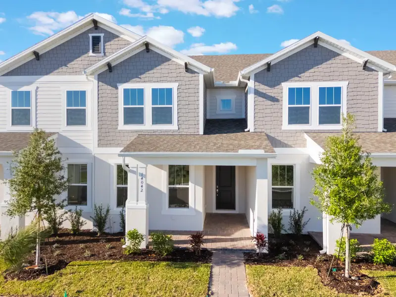 Front exterior of a home in the Harvest at Ovation - Townhomes community, located in Winter Garden, FL (Image 36).