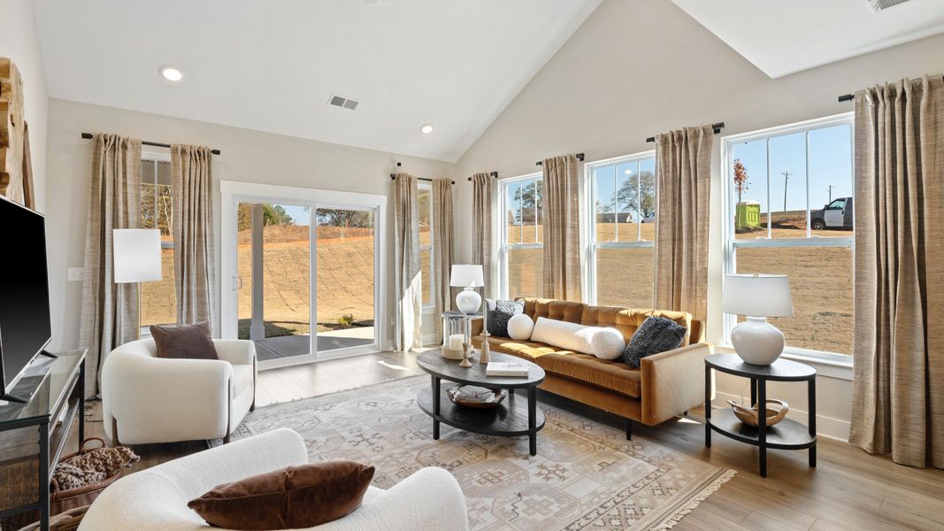 Vibrant family room with high-impact two-story ceilings and thoughtful layout for entertaining Vibrant family room with high-impact two-story ceilings and thoughtful layout for entertaining