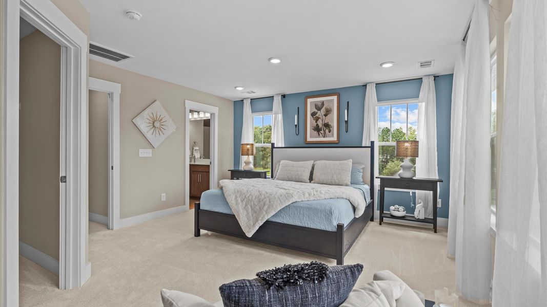 Window adorned primary suite in two story townhome at Ransdell Pointe by DRB Homes in Spartanburg, SC