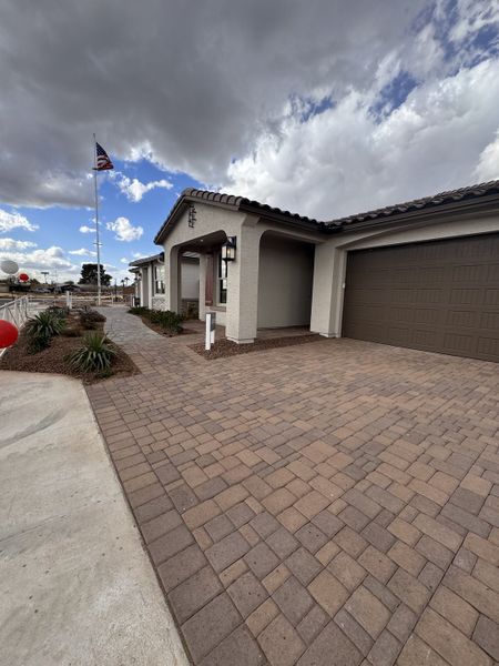 A modern home with a paved driveway and sleek exterior in Seasons at Trevino by Richmond American Homes (Glendale, AZ).