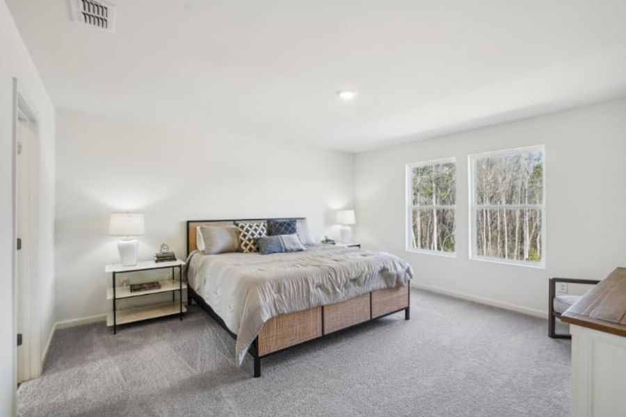 A bedroom with a bed and lamps. A bedroom with a bed and lamps.