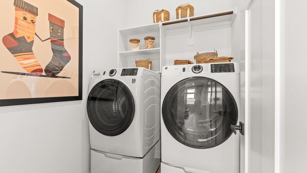 Bright laundry room with premium appliances and ample storage space in Azalea community home.