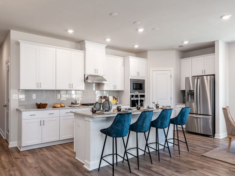 Gather the family around the large kitchen island while cooking dinners.