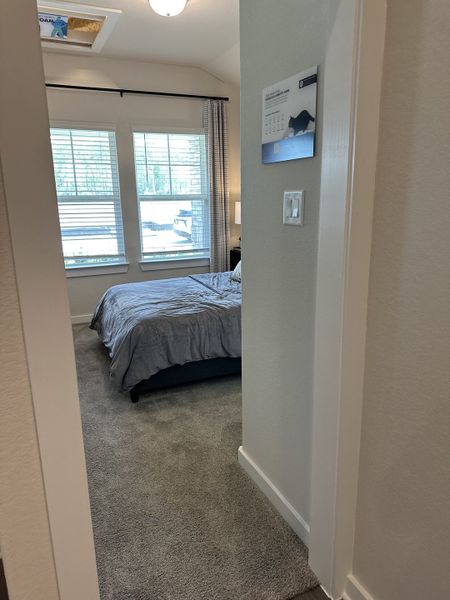A cozy bedroom with plush carpeting, large windows, and soft lighting, inviting a warm and restful atmosphere. A cozy bedroom with plush carpeting, large windows, and soft lighting, inviting a warm and restful atmosphere.