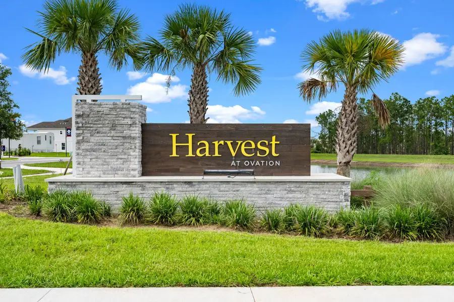 Entrance to the Harvest at Ovation - Townhomes community in Winter Garden, FL, featuring signage and landscaping (Image 2).