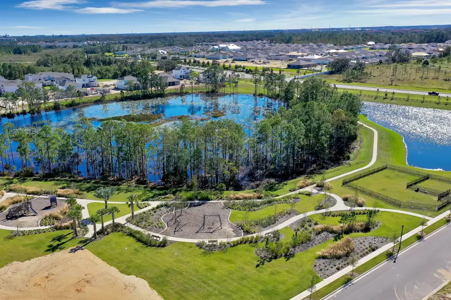 Aerial view of the Harvest at Ovation - Townhomes community in Winter Garden, FL, showing layout and nearby surroundings (Image 13).