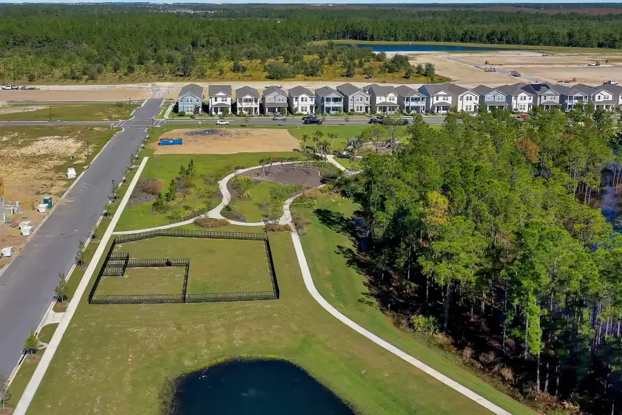 Aerial view of the Harvest at Ovation - Townhomes community in Winter Garden, FL, showing layout and nearby surroundings (Image 12).