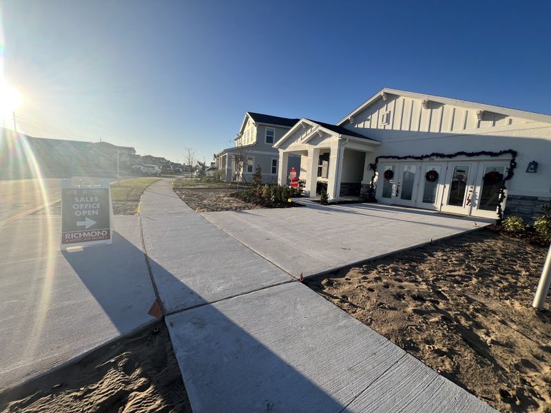 A modern sales office in bright sunlight at Seasons at Eden Hills by Richmond American Homes, Lake Alfred, FL.