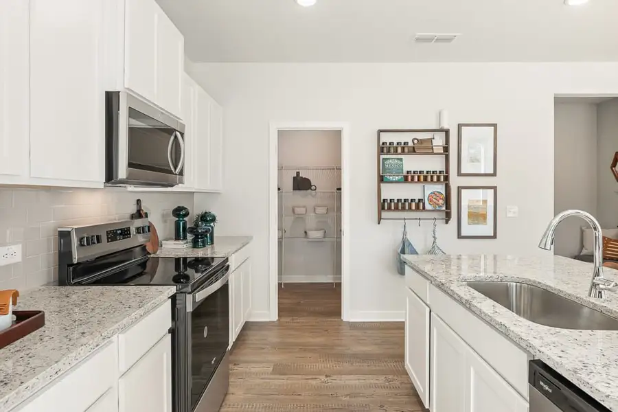 A kitchen with white cabinets. A kitchen with white cabinets.