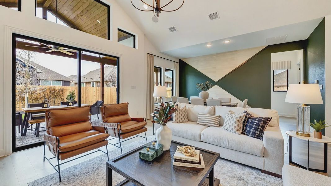 Open-concept living with designer chandelier, lofty ceilings, and chic accents in Hawkes Landing.