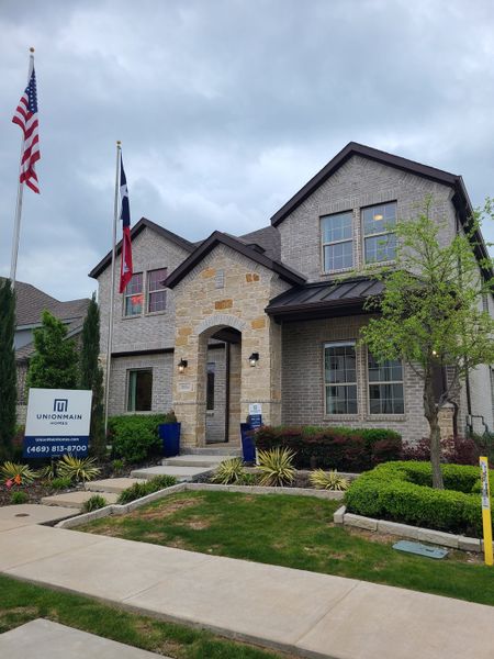 Elegant brick and stone home with lush landscaping in Milrany Ranch by UnionMain Homes (Melissa, TX).