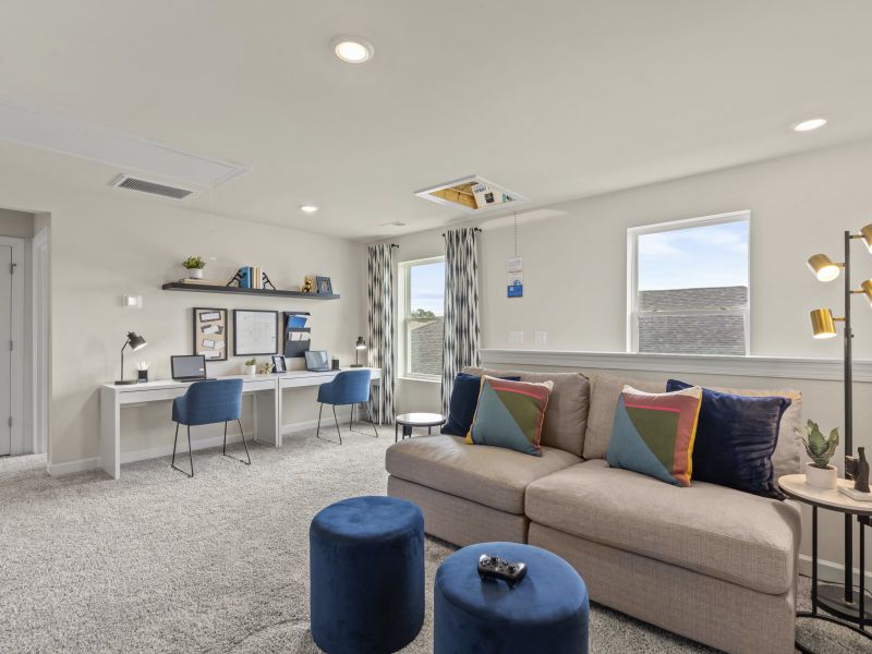 Upstairs, the large loft can accommodate a work/study area and media space.