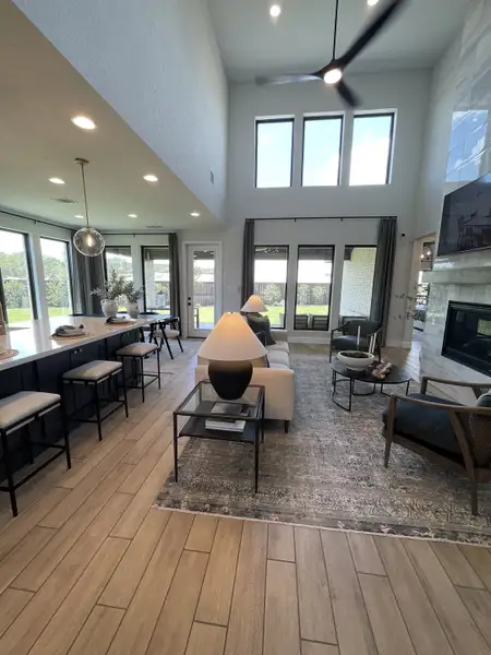 An elegant open living area with high ceilings, large windows, and modern decor, offering natural light and inviting ambiance. An elegant open living area with high ceilings, large windows, and modern decor, offering natural light and inviting ambiance.