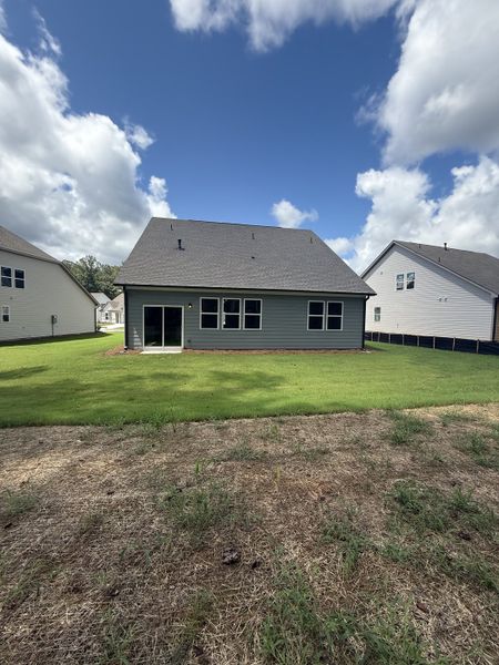 A modern home with a spacious backyard and green lawn in Candleberry Place by Lennar (Sharpsburg, GA).