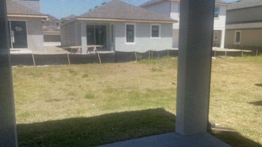 A scenic backyard view from a covered patio in Reunion Village by LGI Homes (Kissimmee, FL).