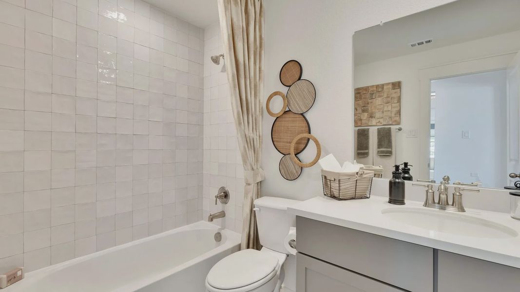 Elegant tiles and modern fixtures enhance this exquisite bathroom in Hunters Glen community. Elegant tiles and modern fixtures enhance this exquisite bathroom in Hunters Glen community.