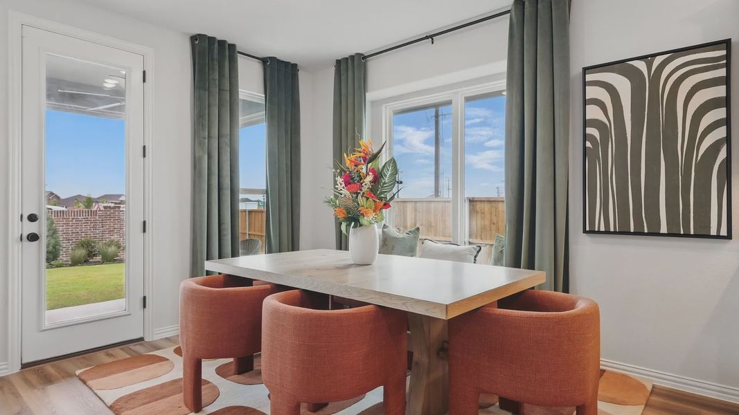 Chic dining space features modern table, plush chairs, and garden view in luxurious Westridge enclave.