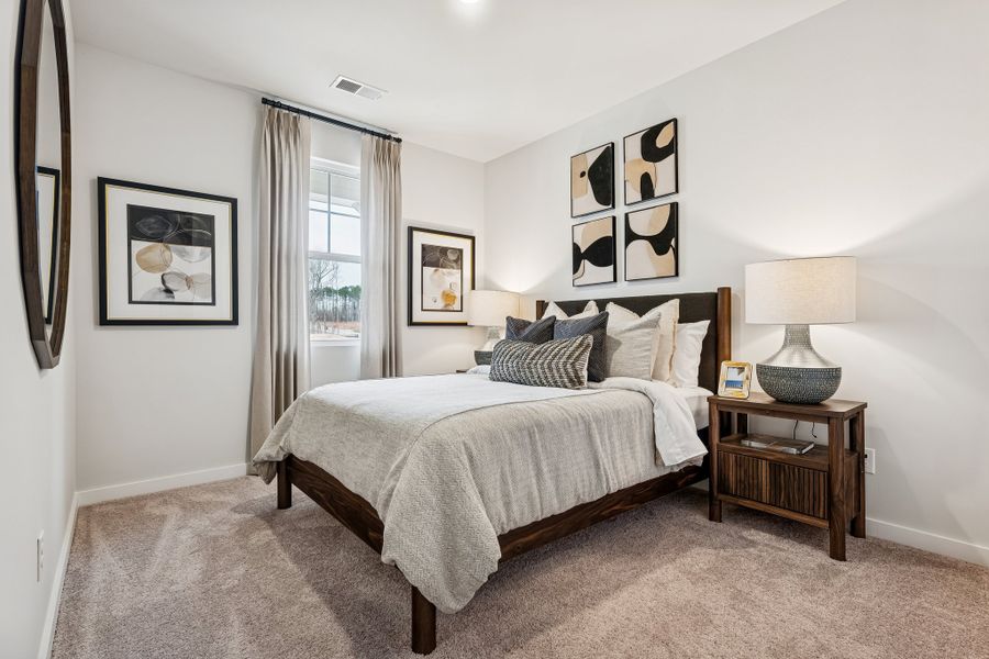A bedroom with a bed and a lamp. A bedroom with a bed and a lamp.