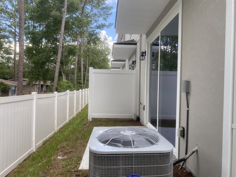 A modern home exterior with a white fence and patio area in Briarwood by D.R. Horton (Jacksonville, FL). A modern home exterior with a white fence and patio area in Briarwood by D.R. Horton (Jacksonville, FL).