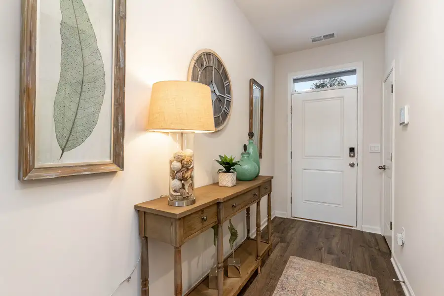 Furnished interior in a model home at Island Green in Myrtle Beach (Image 45).