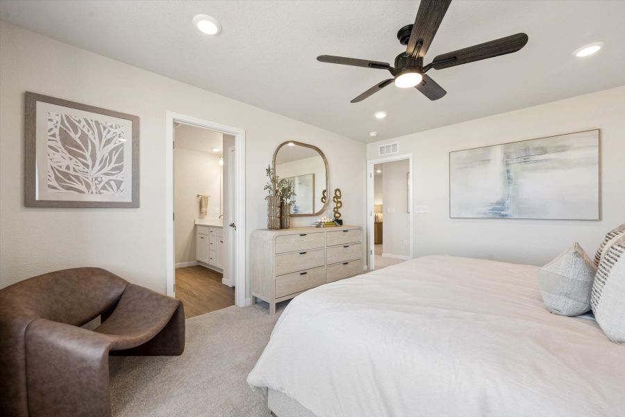 A bedroom with a bed and a chair. A bedroom with a bed and a chair.