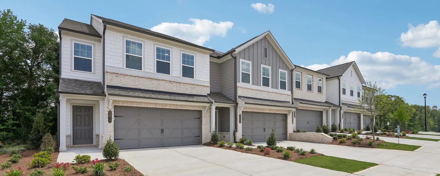 Front exterior of a home in the Eastlyn Crossing - Townhomes community, located in Flowery Branch, GA (Image 2). Front exterior of a home in the Eastlyn Crossing - Townhomes community, located in Flowery Branch, GA (Image 2).