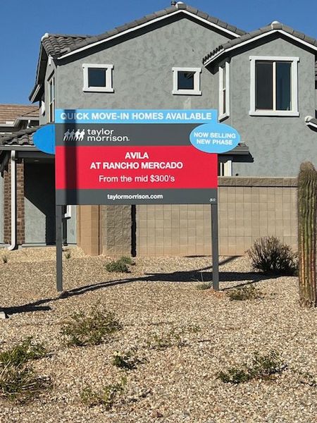 A modern blue-gray home with desert landscaping in Ravenna at Rancho Mercado by Taylor Morrison (Surprise, AZ).