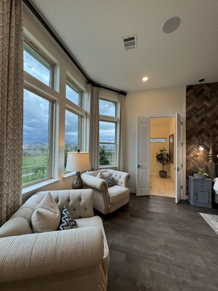 A cozy living space featuring elegant armchairs, neutral tones, and large windows showcasing an inviting view. A cozy living space featuring elegant armchairs, neutral tones, and large windows showcasing an inviting view.