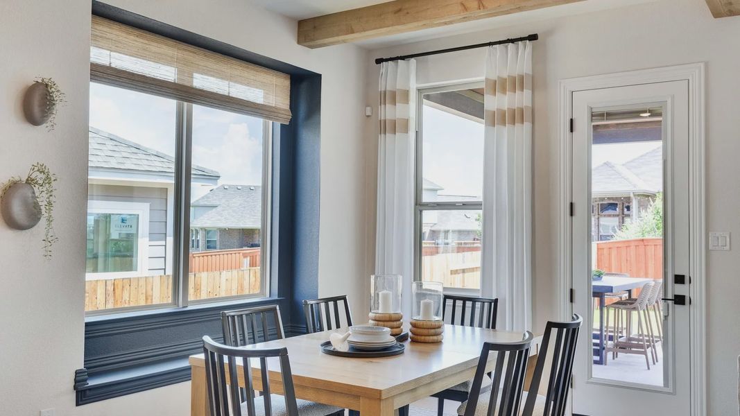 Elegant wooden beams and expansive windows define this Sunfield dining room in Buda, Texas. Elegant wooden beams and expansive windows define this Sunfield dining room in Buda, Texas.