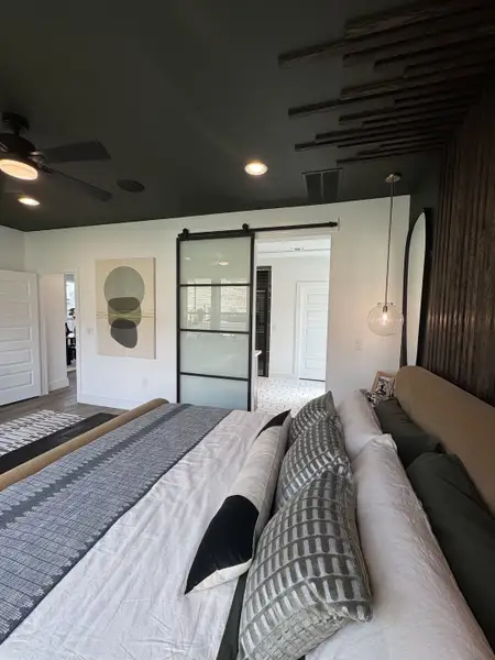 Modern bedroom with bold decor, sliding glass door, textured pillows, and stylish lighting. Modern bedroom with bold decor, sliding glass door, textured pillows, and stylish lighting.