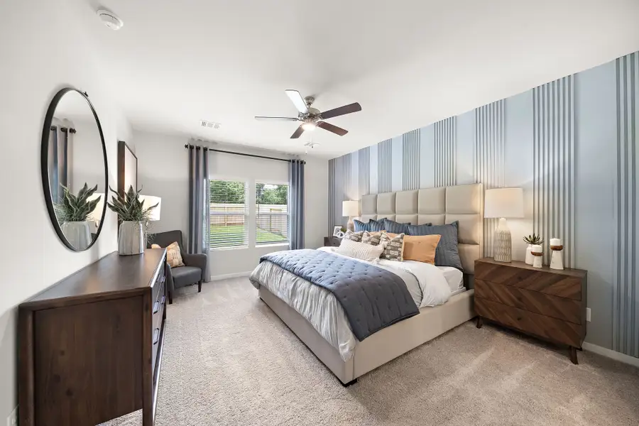 A bedroom with a bed and a mirror. A bedroom with a bed and a mirror.