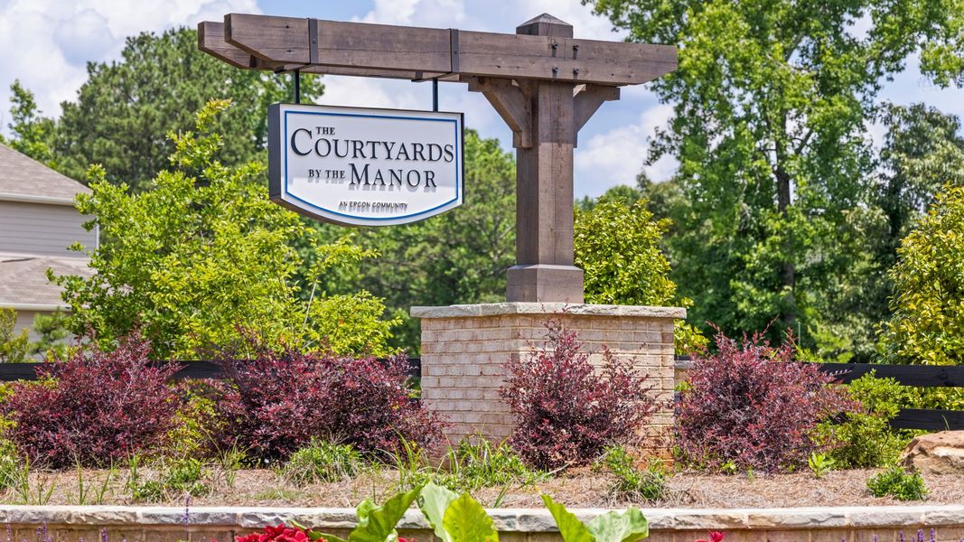Entrance to the The Courtyards by The Manor community in Alpharetta, GA, featuring signage and landscaping (Image 2). Entrance to the The Courtyards by The Manor community in Alpharetta, GA, featuring signage and landscaping (Image 2).