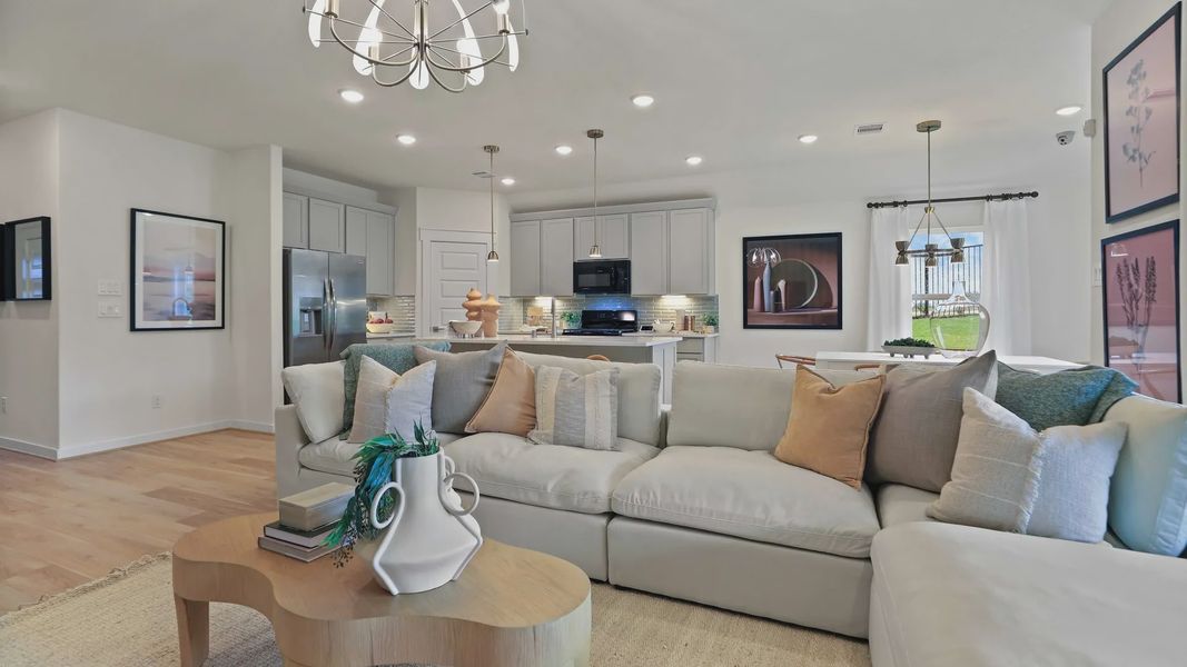 Luxurious open layout with elegant chandelier and gourmet kitchen in Mostyn Springs exudes refined sophistication. Luxurious open layout with elegant chandelier and gourmet kitchen in Mostyn Springs exudes refined sophistication.