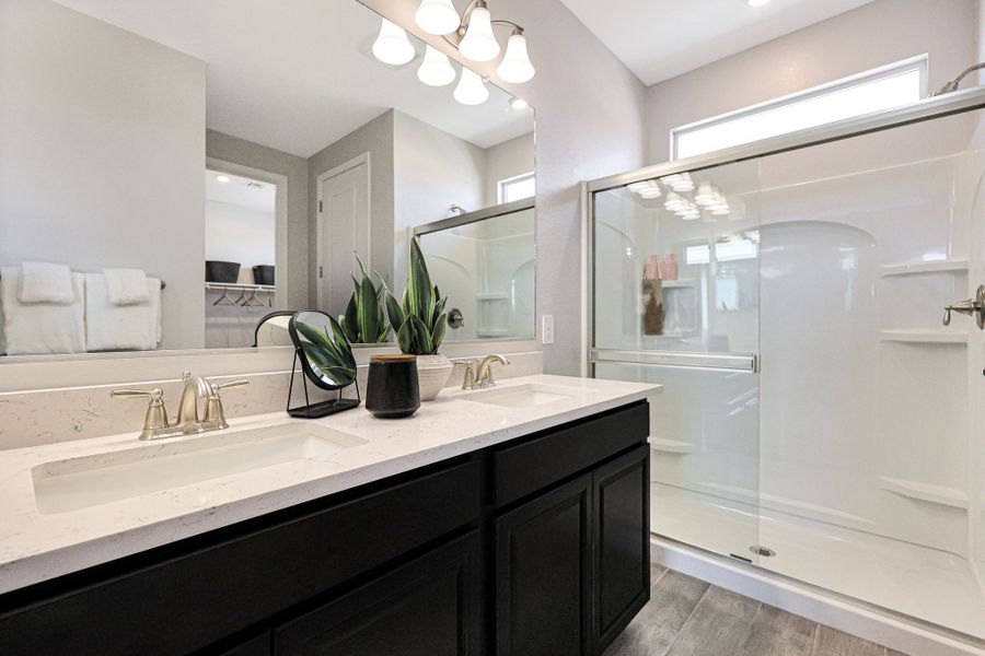 A bathroom with a glass shower. A bathroom with a glass shower.