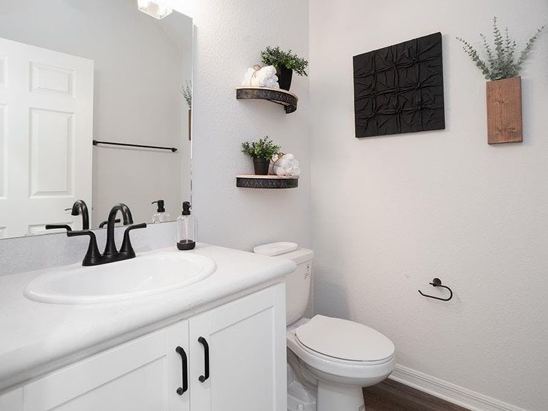 And, a convenient downstairs powder room is available for guests - Aria model home in St. Cloud, FL And, a convenient downstairs powder room is available for guests - Aria model home in St. Cloud, FL