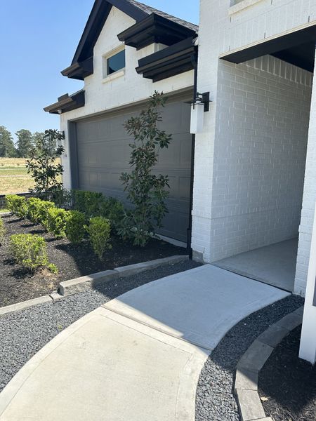 A modern white brick home with elegant landscaping in Montgomery Bend by Pulte Homes (Montgomery, TX). A modern white brick home with elegant landscaping in Montgomery Bend by Pulte Homes (Montgomery, TX).