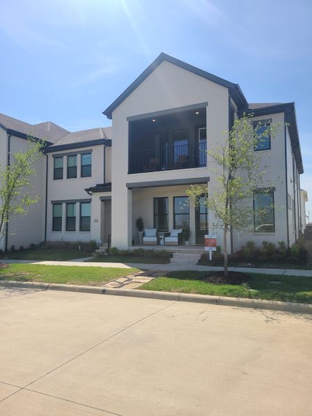 A modern two-story home with a cozy porch and balcony in Hazelwood by CB JENI Homes (Frisco, TX).