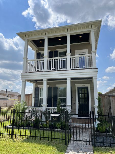 A charming two-story home with a fenced yard in Pearland Old Townsite by Sullivan Brothers Builders (Pearland, TX).