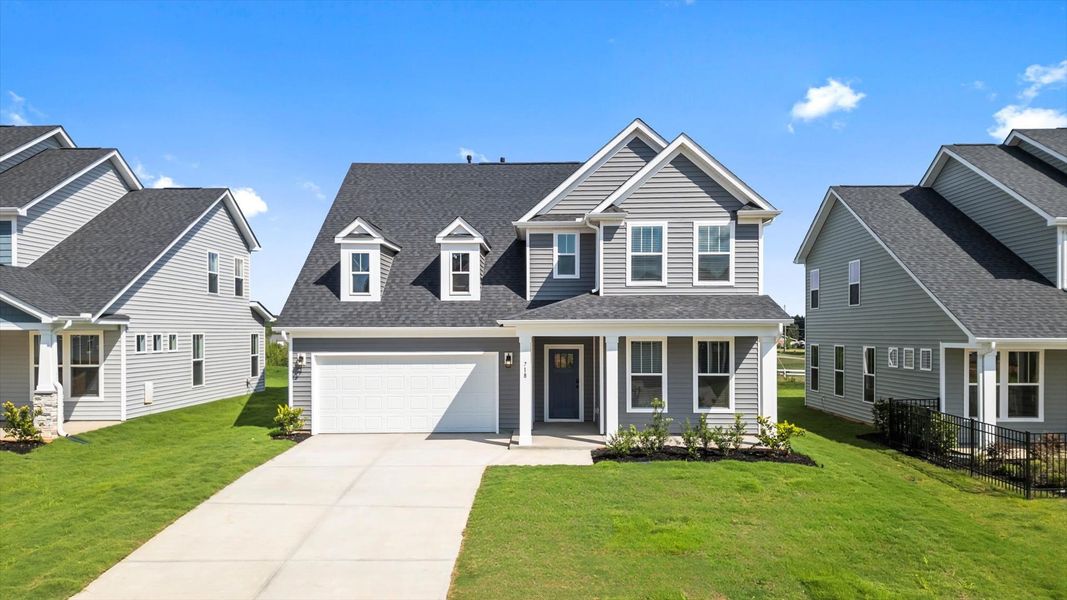 Notable street presence with tasteful elevation and thoughtful landscaping of the Drayton floorplan Notable street presence with tasteful elevation and thoughtful landscaping of the Drayton floorplan