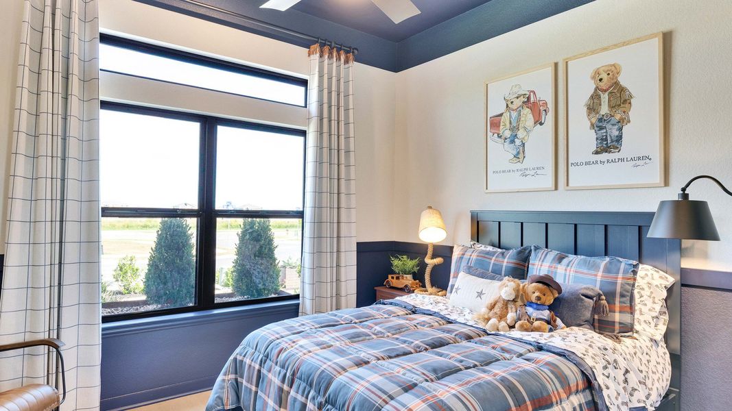 Elegant plaid bedding complements large windows and stylish art in this Preserve at Lakeside Meadows bedroom. Elegant plaid bedding complements large windows and stylish art in this Preserve at Lakeside Meadows bedroom.