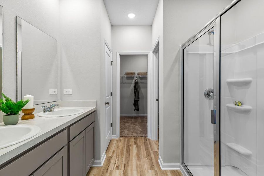 A bathroom with a shower and sink. A bathroom with a shower and sink.