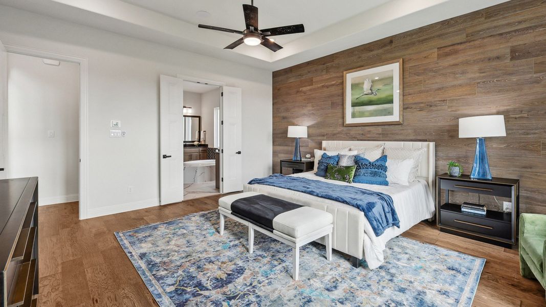 Exquisite wood-paneled accent wall elevates modern bedroom in Green Meadows. Luxurious details throughout.