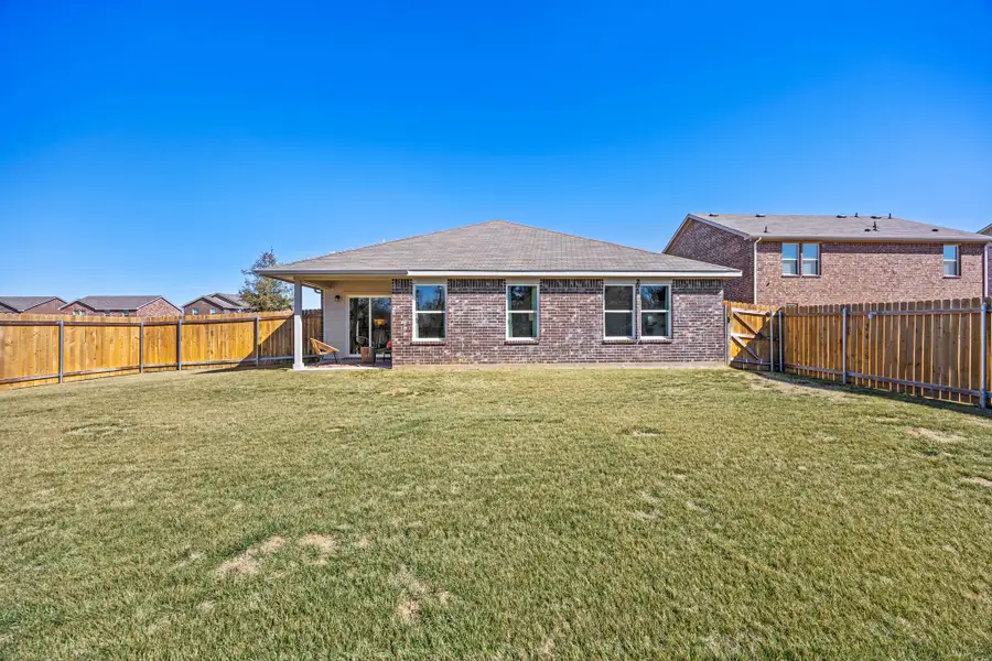 A house with a fence and grass. A house with a fence and grass.