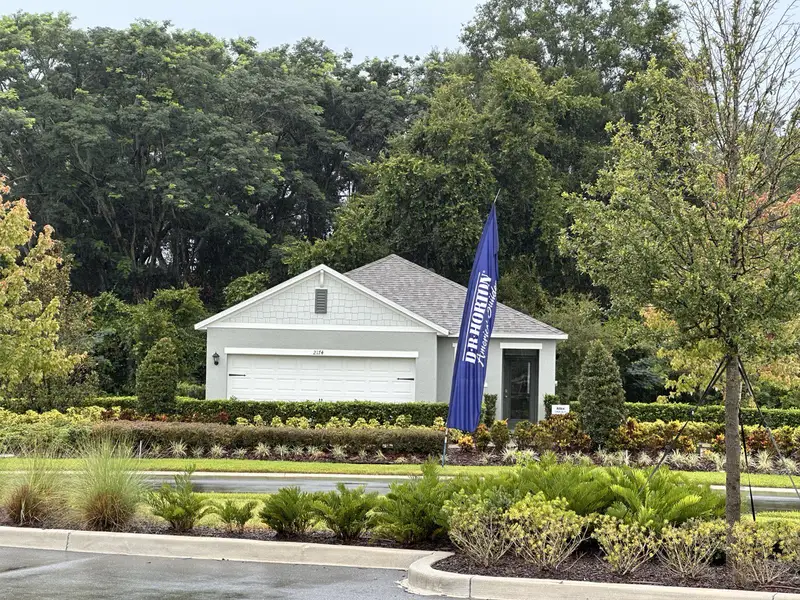 A charming grey home with lush landscaping in Wynwood by D.R. Horton (Ocoee, FL).
