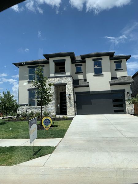 Modern two-story home with stone and stucco exterior in Retreat at San Gabriel by Brightland Homes (Georgetown, TX). Modern two-story home with stone and stucco exterior in Retreat at San Gabriel by Brightland Homes (Georgetown, TX).