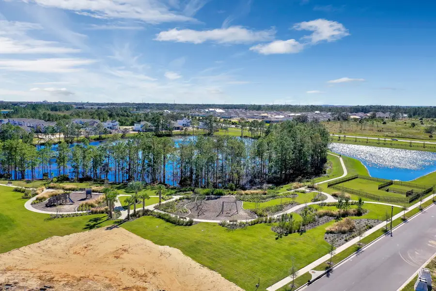 Aerial view of the Harvest at Ovation - Townhomes community in Winter Garden, FL, showing layout and nearby surroundings (Image 14).