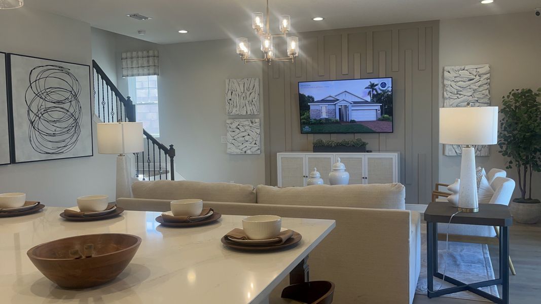 A modern living area with chic decor, a cozy couch, stylish lighting, and abstract artwork, perfect for relaxing and entertaining. A modern living area with chic decor, a cozy couch, stylish lighting, and abstract artwork, perfect for relaxing and entertaining.