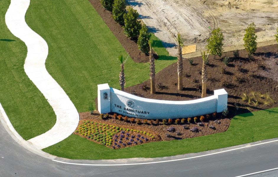 Entrance to the The Sanctuary at Sunset Beach community in Sunset Beach, NC, featuring signage and landscaping (Image 10).