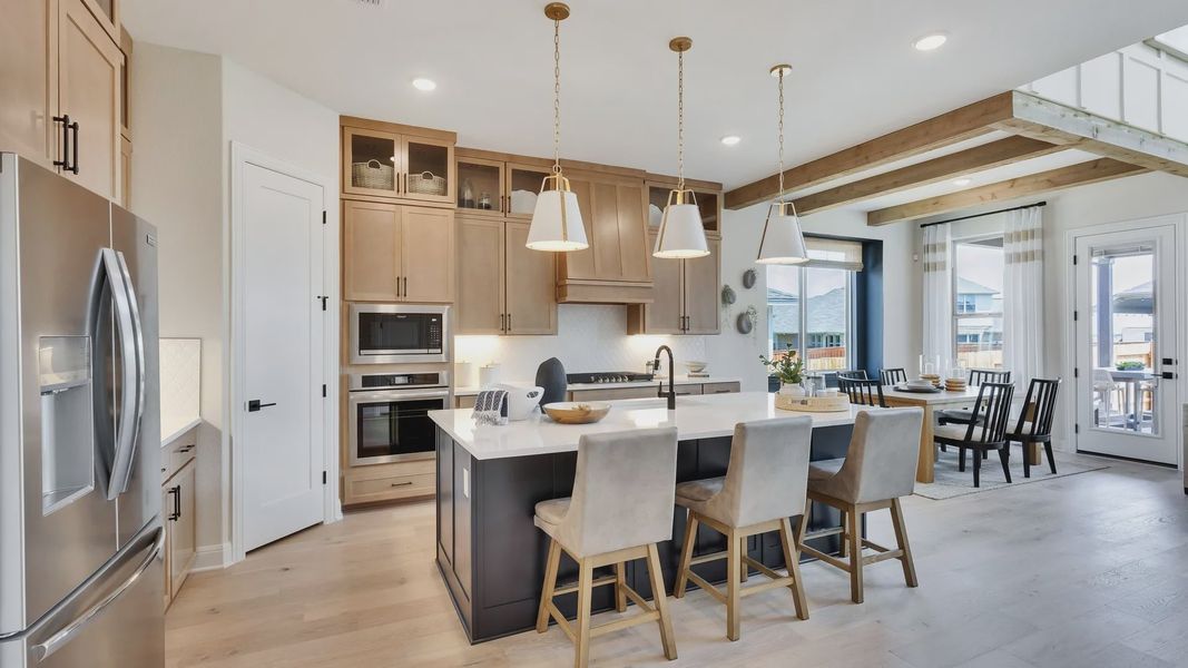Sunfield's kitchen boasts a sleek island, premium wood cabinetry, and elegant pendant lighting. Sunfield's kitchen boasts a sleek island, premium wood cabinetry, and elegant pendant lighting.