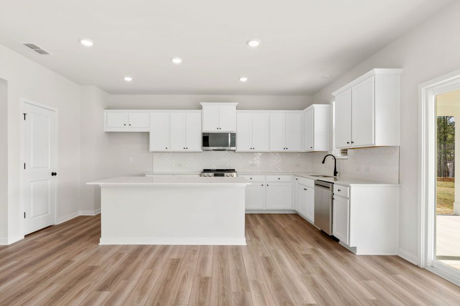 A kitchen with white cabinets. A kitchen with white cabinets.